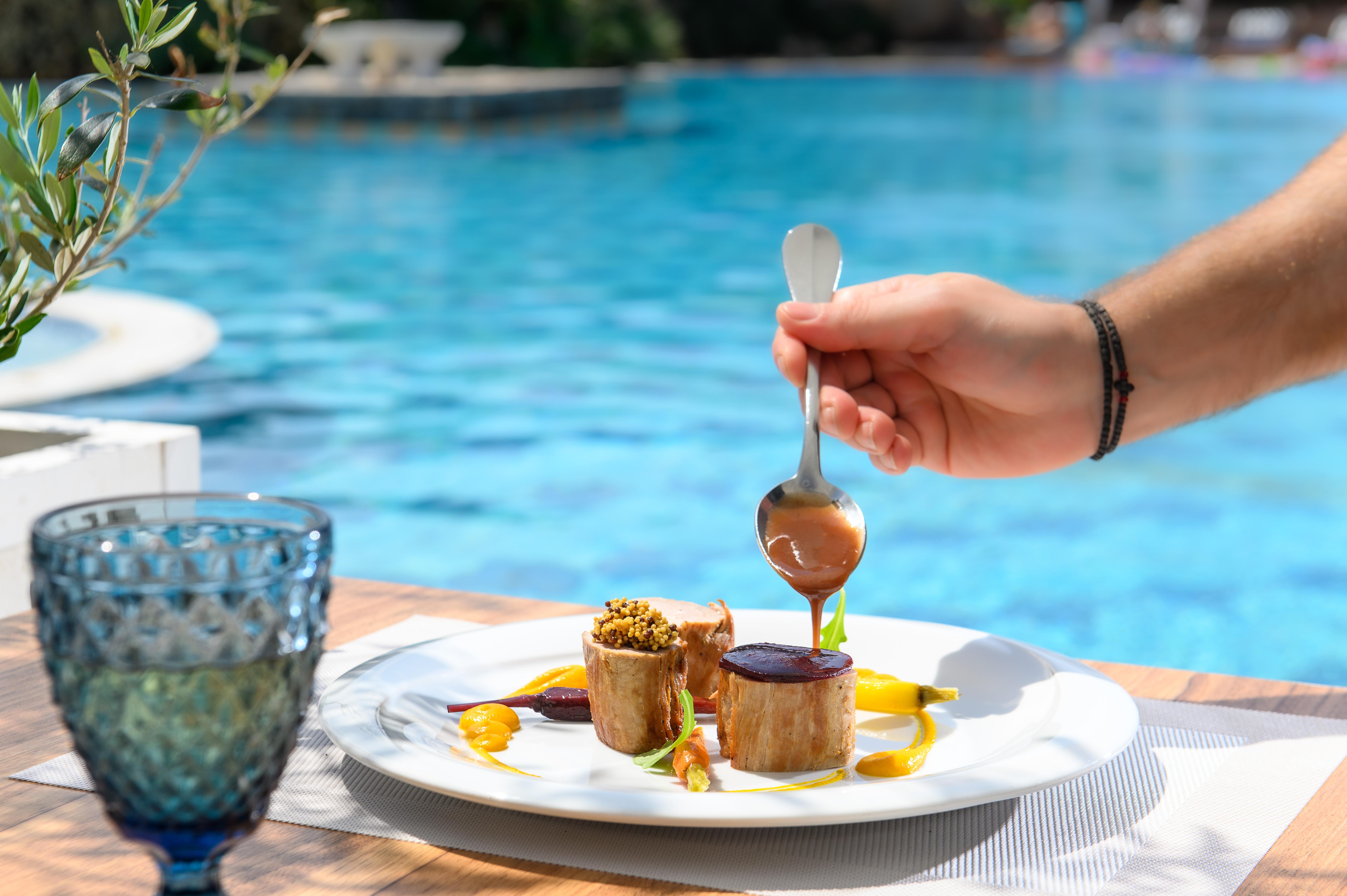 Minos Imperial Luxury Beach Resort & Spa Milatos Extérieur photo A hand holding a spoon