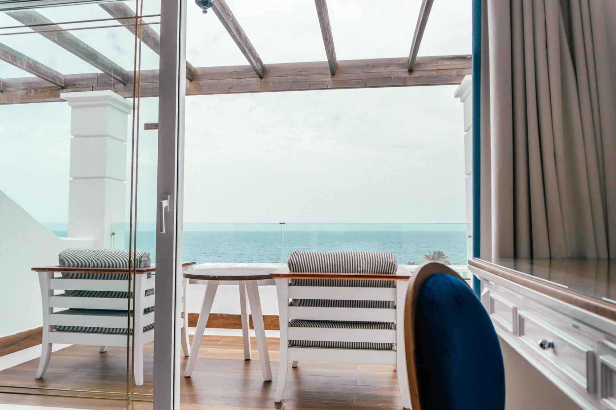 Minos Imperial Luxury Beach Resort & Spa Milatos Extérieur photo A view from the balcony of a suite on board the World Voyager